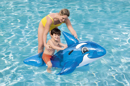 Kids playing on the Bestway blue whale ride-on pool float in a backyard swimming pool