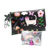 two faux leather pouches ready to decorate with more than 100 colourful rub-on transfers from Djeco