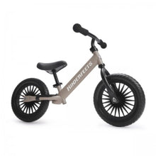 Kinderfeets children's balance bike in beige with black handlebars, adjustable saddle, footrest and two large black wheels, shown from the side.