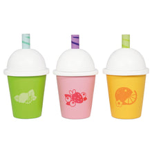 Three Le Toy Van Honeybake wooden smoothie cups lined up, each with a different fruit flavour design