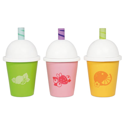Three Le Toy Van Honeybake wooden smoothie cups lined up, each with a different fruit flavour design
