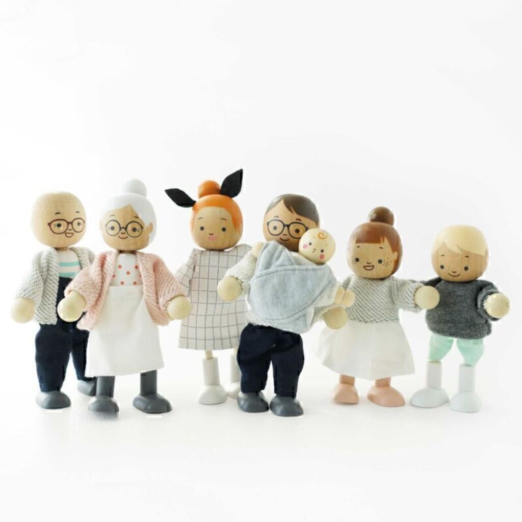 Le Toy Van wooden doll family figures standing in a row, showing their friendly faces and painted outfits