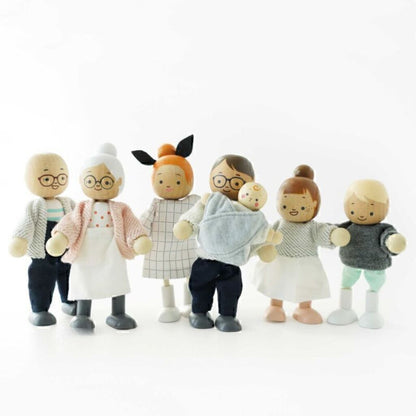 Le Toy Van wooden doll family figures standing in a row, showing their friendly faces and painted outfits