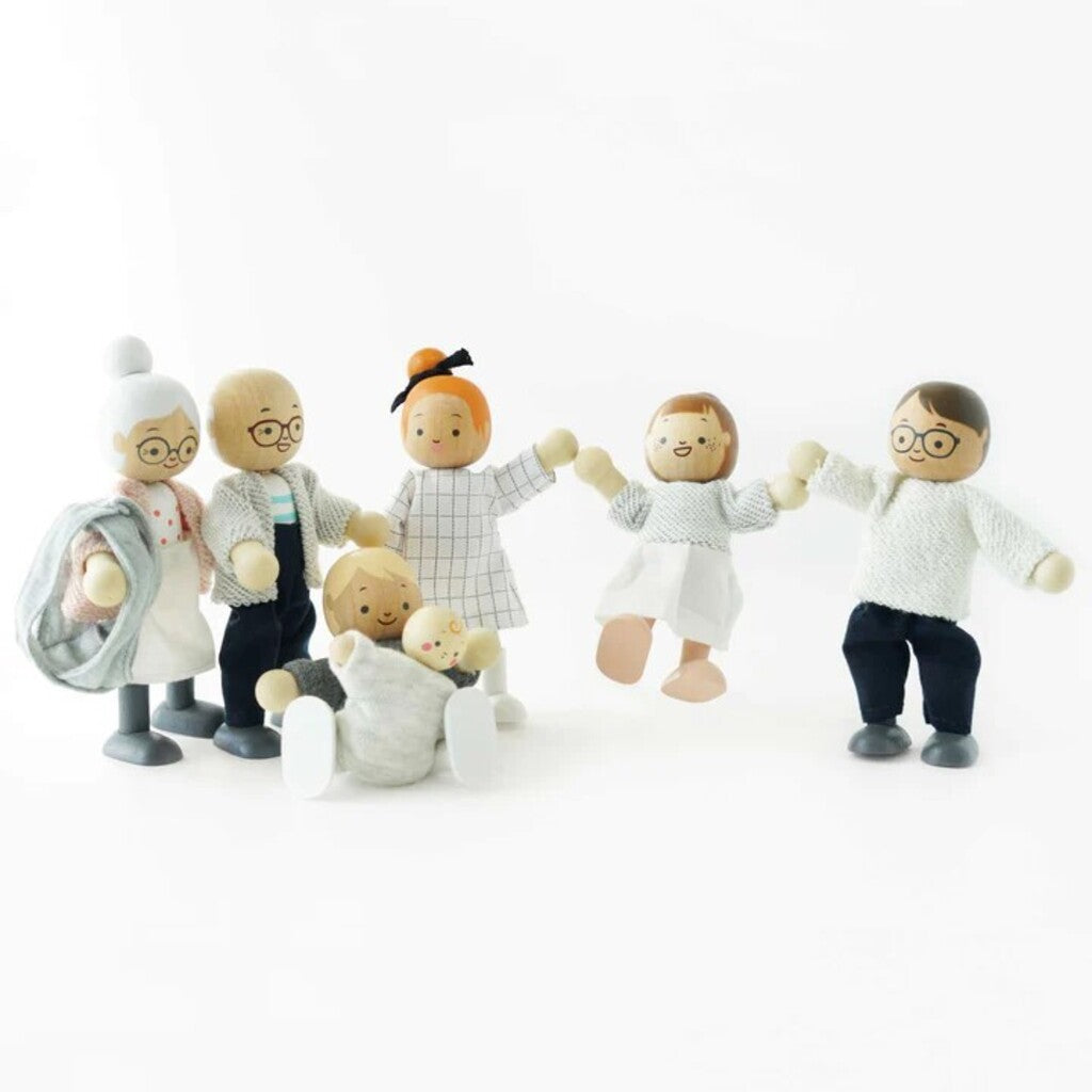 Close-up of a Le Toy Van wooden doll showing its hand-painted face and smooth rounded finish