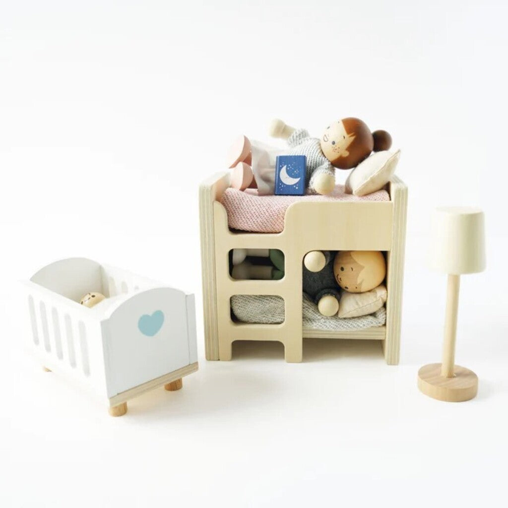 Le Toy Van wooden doll family figures arranged in a doll house kitchen during pretend family play