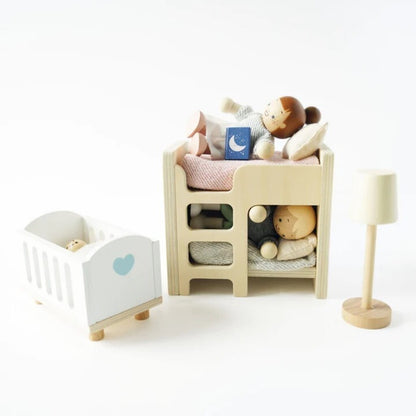 Le Toy Van wooden doll family figures arranged in a doll house kitchen during pretend family play