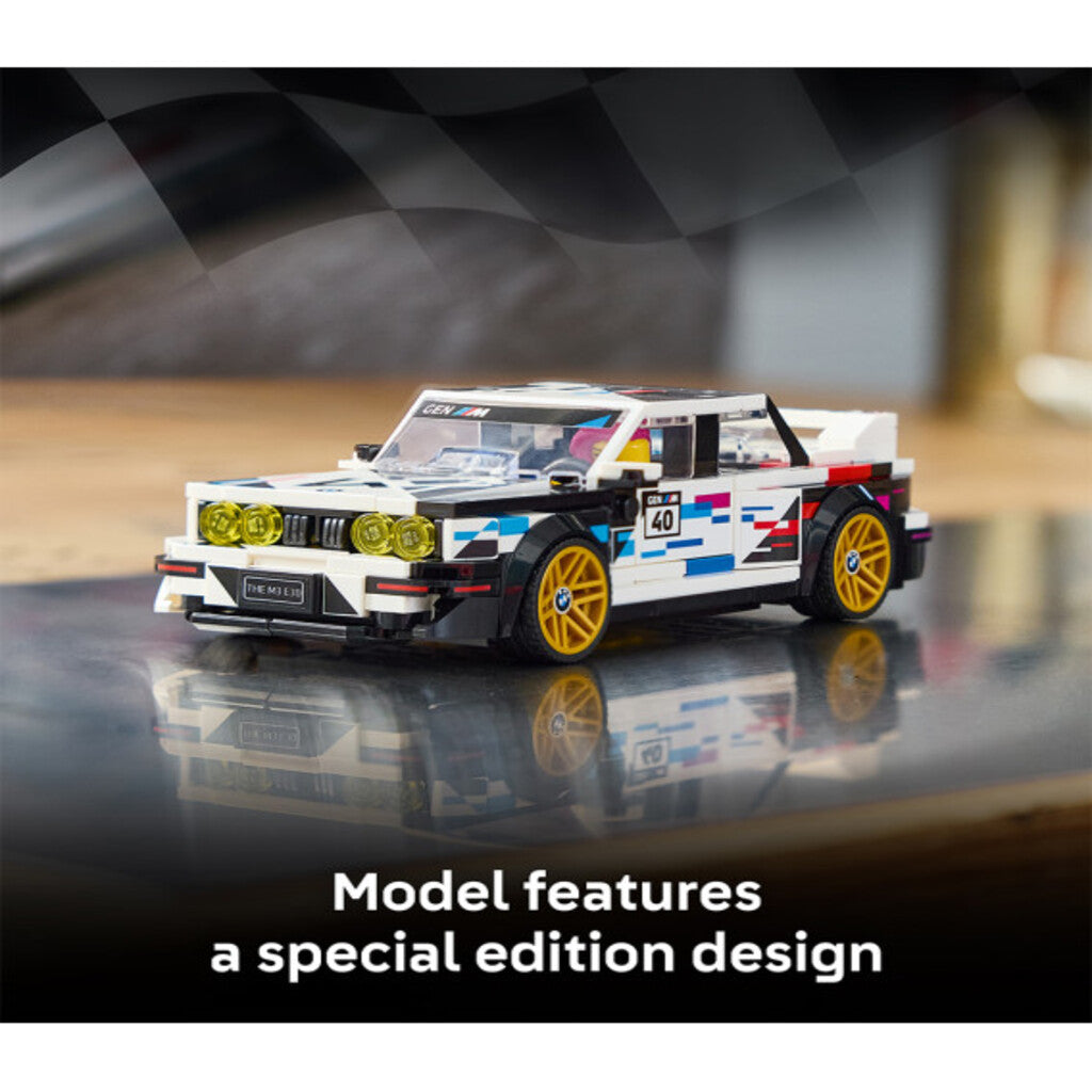 LEGO BMW M3 E30 77263 model displayed on an office desk beside a keyboard and monitor