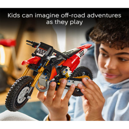 LEGO 42238 Ducati motocross bike displayed on a desk shelf in a home garage setting