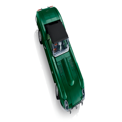 Completed LEGO Jaguar E-Type displayed on a wooden shelf in a home office setting