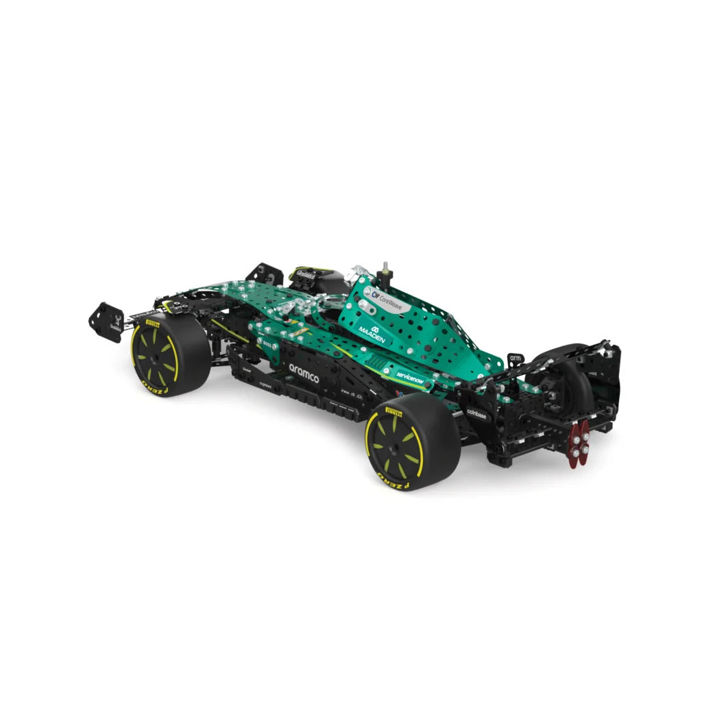 A green and black toy Formula 1 car chassis model with yellow accents on the wheels, shown from a three-quarters perspective on a solid white background.