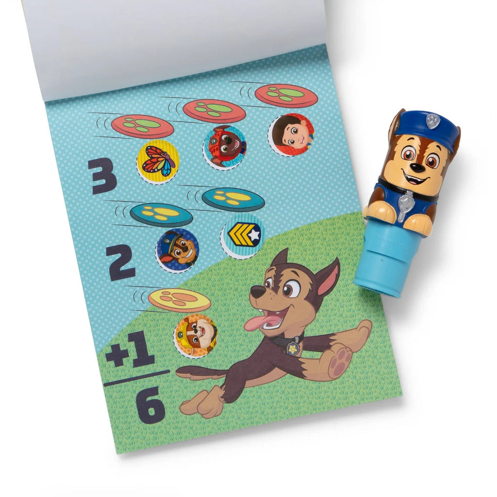 Chase stamper pressing a PAW Patrol sticker onto an activity pad page with no peeling needed