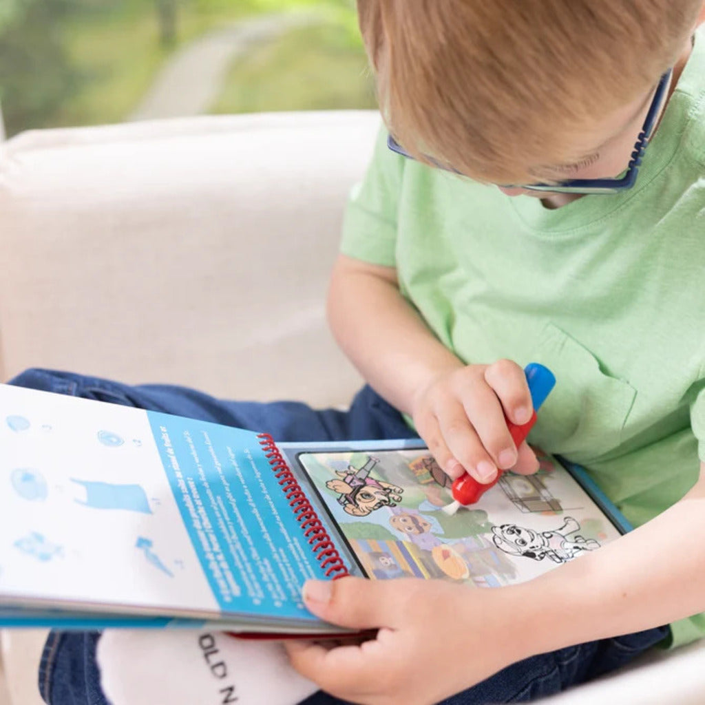 Marshall sticker stamper clipped into the activity pad's built-in storage for mess-free travel