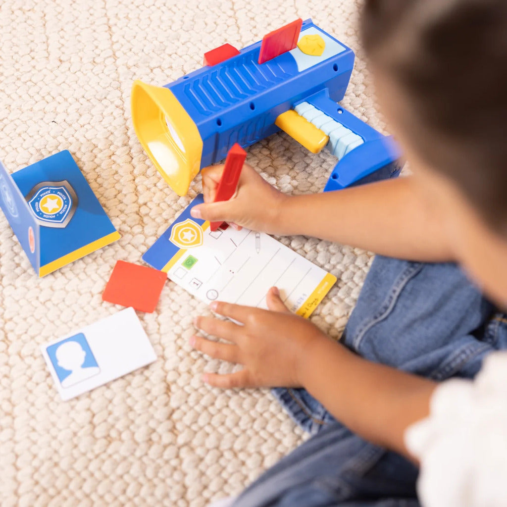 Ticket dispenser on the police radar toy popping out a pretend violation or green reward ticket