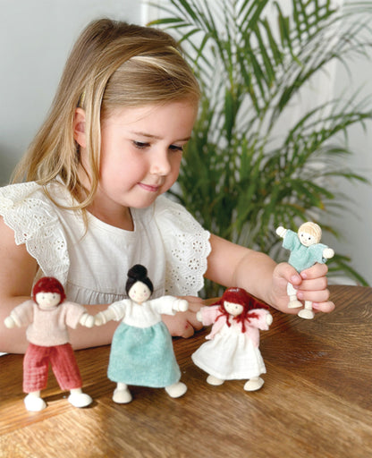 Close-up of a Mentari Honeybunch wooden doll showing its smooth rounded shape and hand-painted details