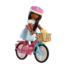PLAYMOBIL Brooklyn Barbie figure riding a pink and turquoise bicycle with front basket and pink helmet