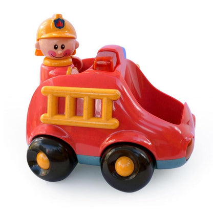 Side view of red toy fire engine with yellow ladder, black wheels and removable firefighter figure, showing the open driver's compartment.