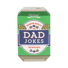 Ridley's Games 'Dad Jokes' card deck in its original green and navy blue packaging, featuring a retro beer-can-inspired design with gold wheat ears and white lettering.