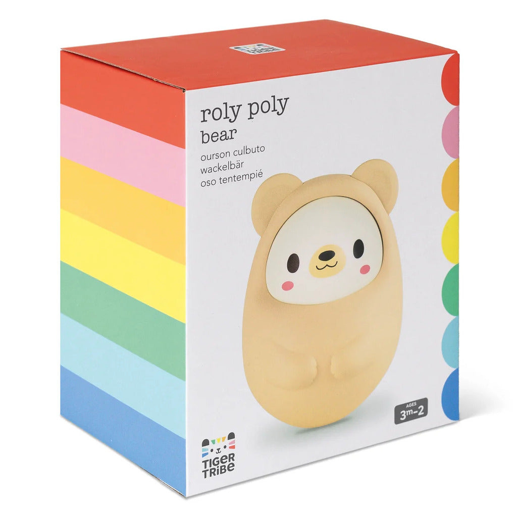 Baby during tummy time reaching for the roly poly bear as it rocks and chimes on the floor