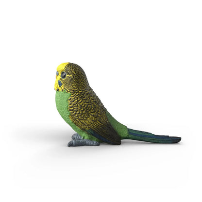 Schleich budgie figure held in a child's hand to show its small and realistic modelled scale