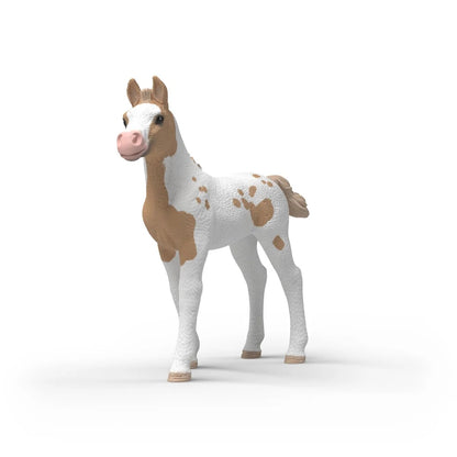 Schleich Collectible Foal Rusty hand-painted figurine showing its beige-spotted coat, white face stripe and pink muzzle