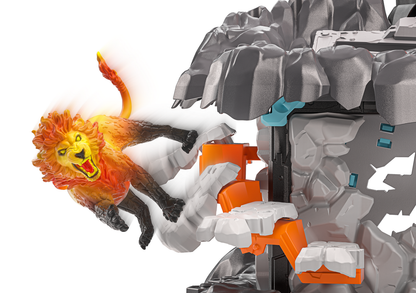 A toy lion figure with a glowing orange and yellow mane and tail, shown climbing or interacting with a gray rocky structure that has orange and blue details, isolated on a white background.