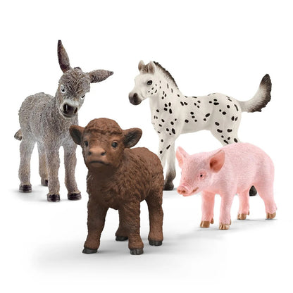 Close-up of a baby farm animal figure showing juvenile proportions and painted coat detail