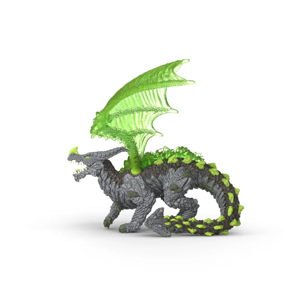Rock Dragon figure posed on a pile of real stones during imaginative outdoor play in a garden