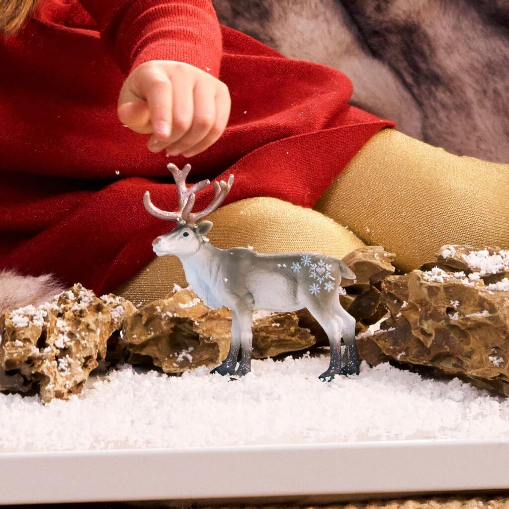 Rear view of the rose gold reindeer figure showing its raised tail and slender sculpted legs