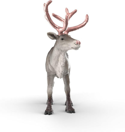 Rose Gold Reindeer placed on a mantelpiece among Christmas decorations and greenery