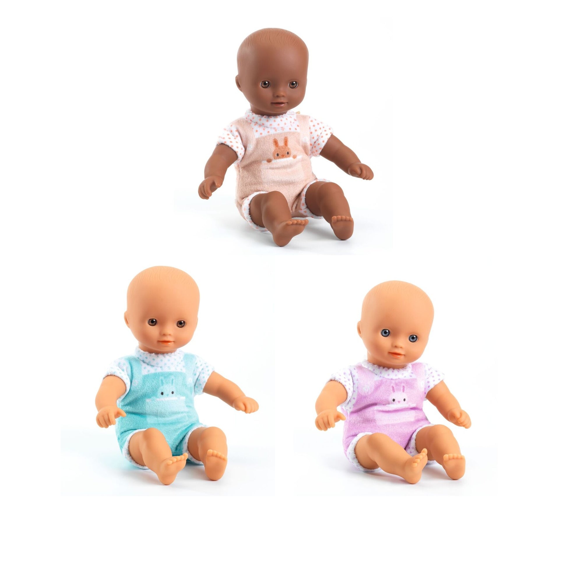 Three soft-bodied baby dolls in pink, blue and beige outfits sitting together on a white background.