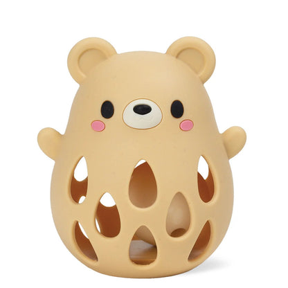 Side view of the bear silicone rattle showing its rounded ear loop and smooth moulded face detail