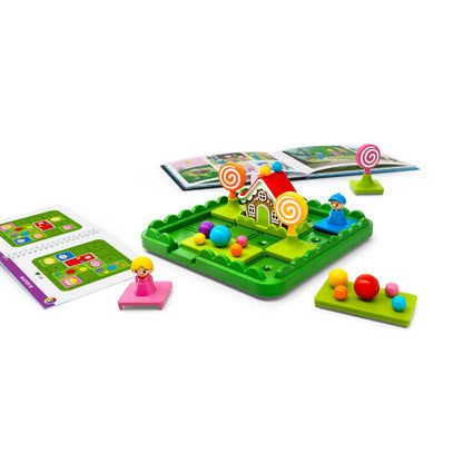 SmartGames Hansel & Gretel game board with sliding puzzle pieces, illustrated storybook and challenge booklet