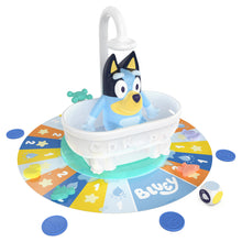 Close-up of the Bluey figure sitting in the bathtub with the shower knob raised ready to press