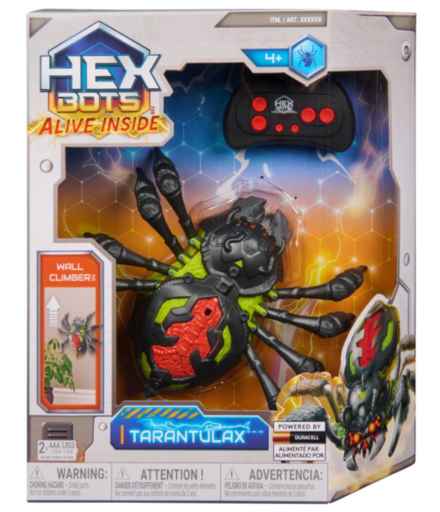 Hex Bots RC crawling spider robot on eight articulated legs beside its infrared remote control