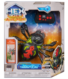 Hex Bots RC crawling spider robot on eight articulated legs beside its infrared remote control
