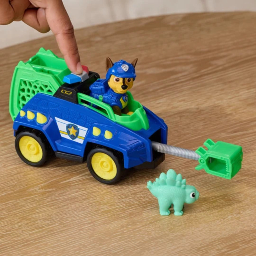 Child pushing the Chase Dino Movie cruiser across the carpet during a prehistoric rescue mission