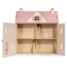 the wooden dolls house viewed from the side showing all three floors and the attic