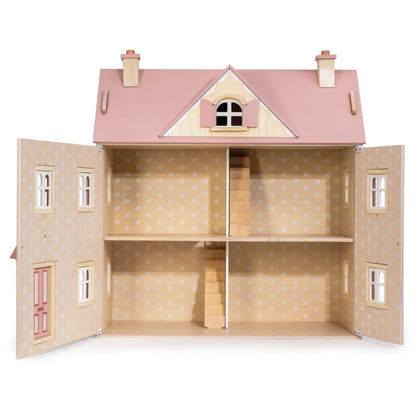 the wooden dolls house viewed from the side showing all three floors and the attic