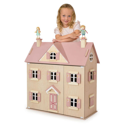 The dolls house with its front panels opened wide, revealing all five furnished rooms