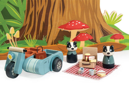 The picnic laid out on the blanket with sandwiches, Battenberg cake, cups and flask