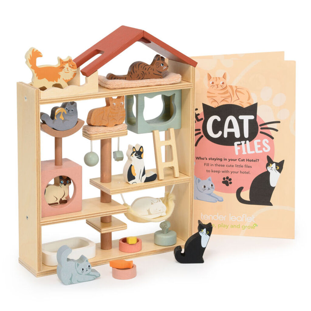 a child arranging the wooden cats into their beds inside the Purrfect Stay hotel