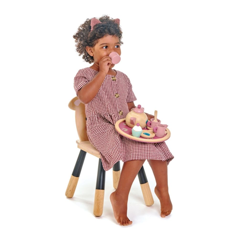 Child pouring pretend tea with the Tender Leaf Toys Birdie wooden tea set during a picnic game