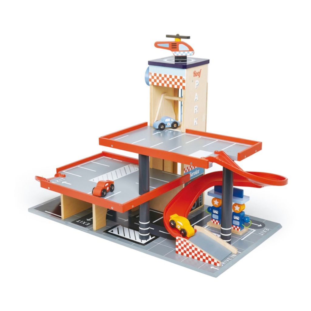 Child driving a toy car through the Tender Leaf Toys Blue Bird wooden service station