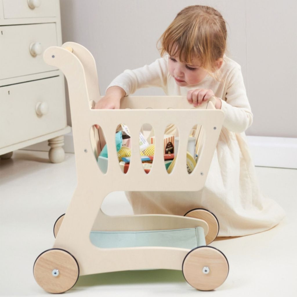 Fabric storage basket on the Tender Leaf Toys shopping cart filled with wooden play food