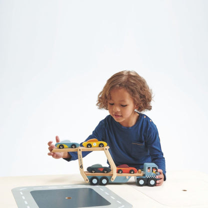 Close-up of the smooth-rolling wheels and cab of the Tender Leaf Toys wooden car transporter