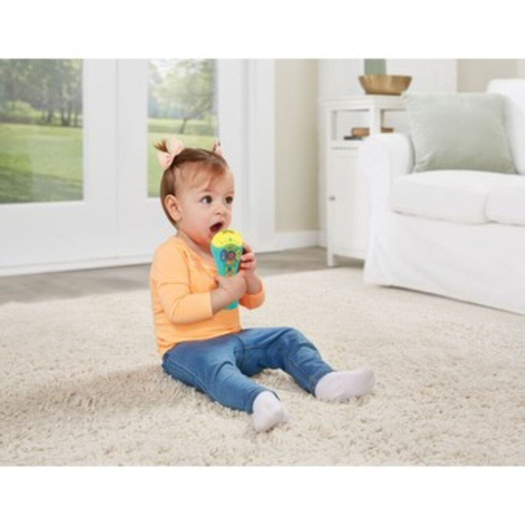 Toddler playing with VTech Sing Songs Microphone musical toy during pretend singing play