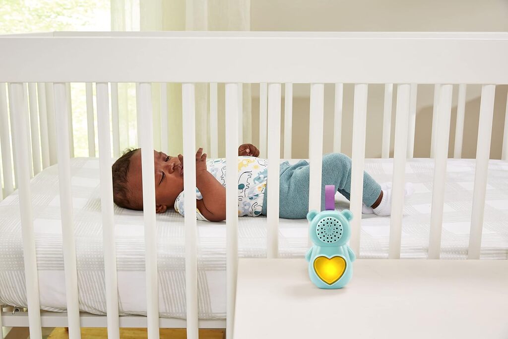 Baby Soothing Bear held in an adult hand showing the plush size suitable for cuddling