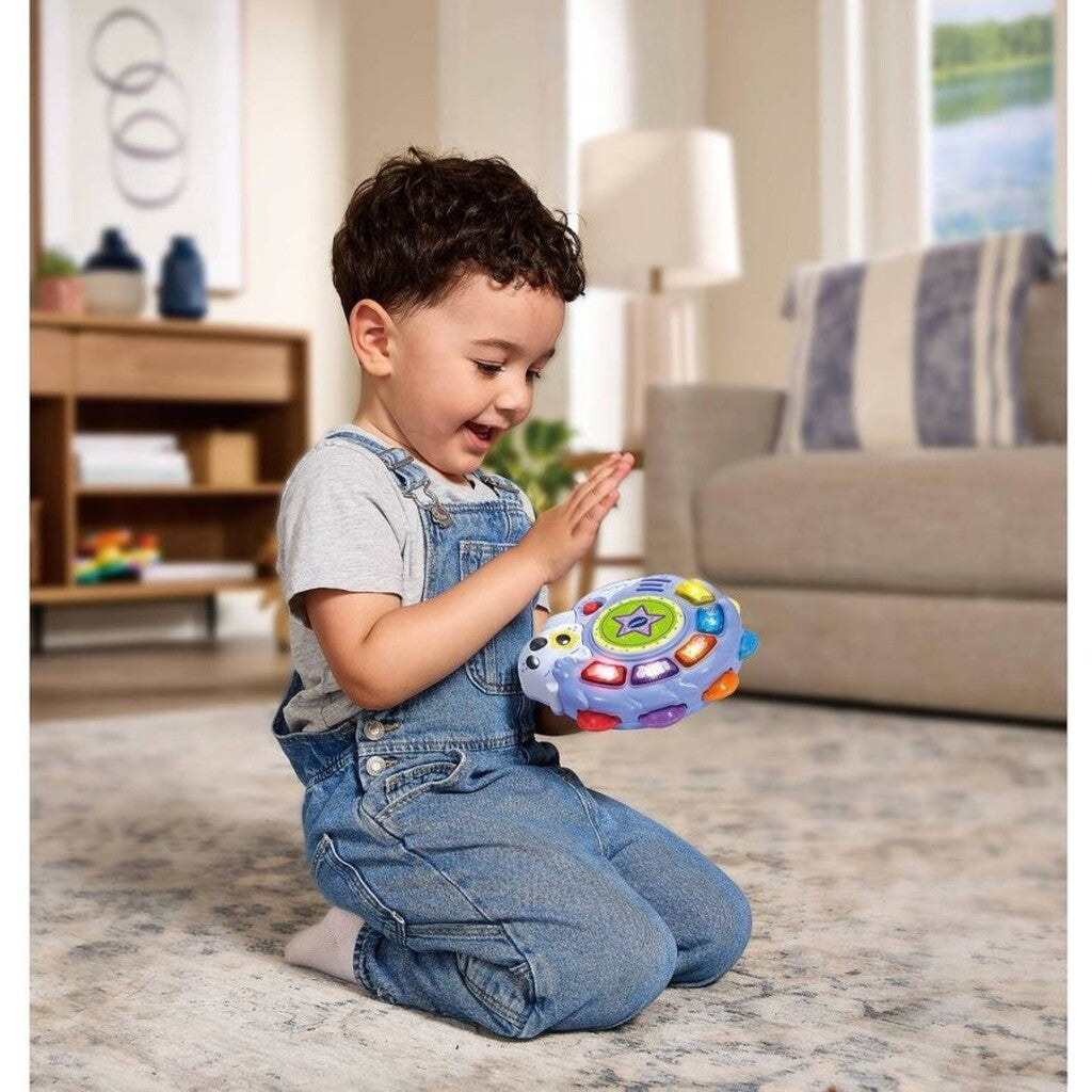 Child playing with VTech Tapping Tunes Tambourine musical toy