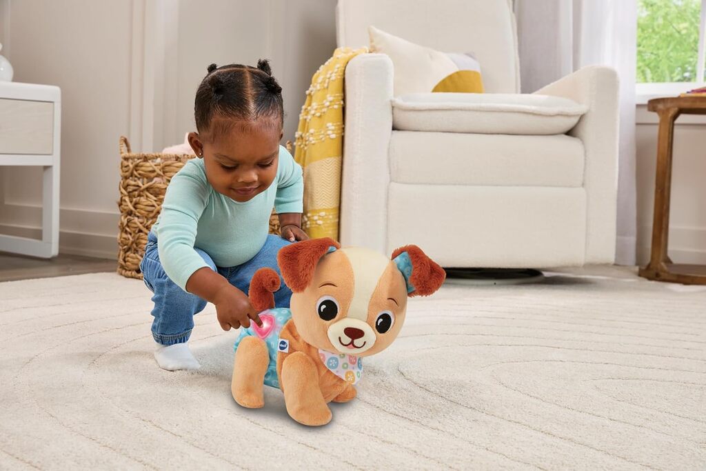 Baby Walk & Wag Puppy held in an adult hand showing the toy's size relative to a palm