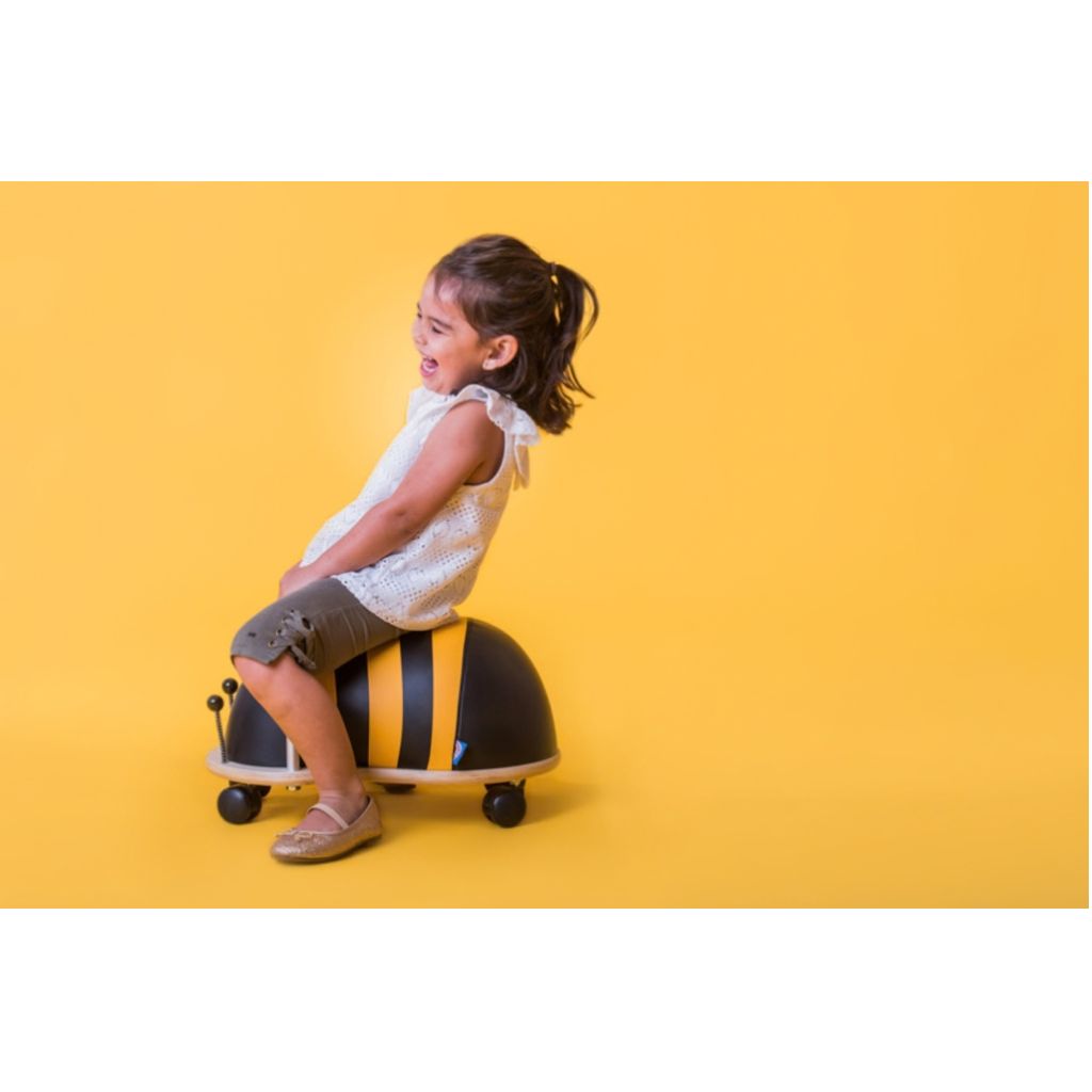 Back view of the Wheely Bug large bee ride-on showing its yellow and black stripes and wing details
